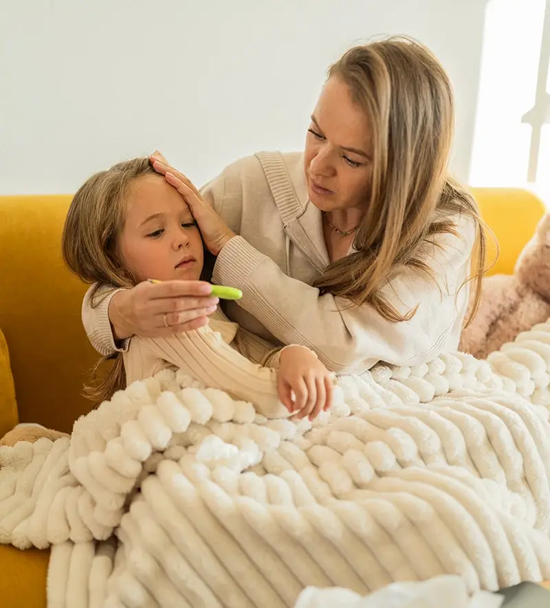 Mother checking daughter's temperature
